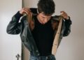 person wearing a jacket and showing their upper body
