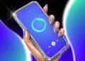 A hand holding a phone displaying the AI DJ UI screen on a gradient background