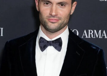 Penn Badgley in a tux with short hair.