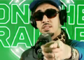Artist Fenix Flexin in front of a microphone and pointing at the camera