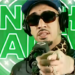 Artist Fenix Flexin in front of a microphone and pointing at the camera