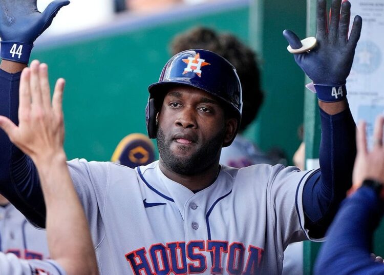 Houston Astros' Yordan Alvarez celebrating in the dugout