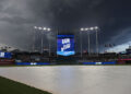 KANSAS CITY, MO - JULY 11: Dark clouds fill the skies as the scoreboard shows a rain delay before an MLB game between the New York Mets and Kansas City Royals on July 11, 2025 at Kauffman Stadium in Kansas City, MO. (Photo by Scott Winters/Icon Sportswire via Getty Images)