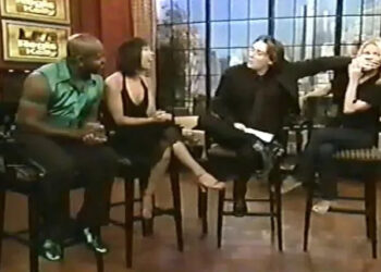 Clay Aiken covers Kelly Ripa's mouth during an interview with Emmitt Smith and Cheryl Burke
