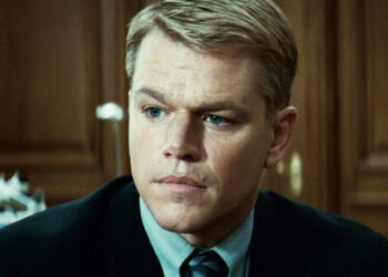 Matt Damon's Francois Pienaar looks serious as he sits in a suit in Invictus