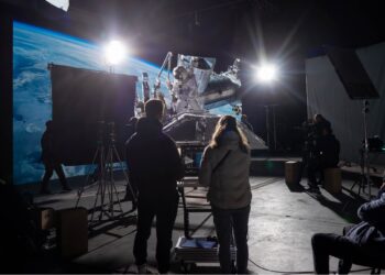 a movie set with production crew watching a scene