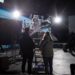 a movie set with production crew watching a scene