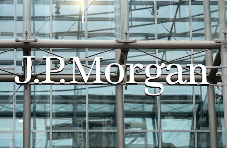 The image shows the J.P. Morgan logo on a glass building facade with metal framework.