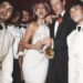 Bride and groom celebrating with friends and champagne.