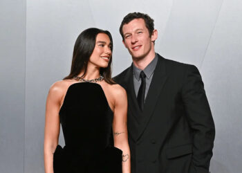 Evan Agostini/AP Photo/Evan Agostini - PHOTO: Dua Lipa, left, and Callum Turner arrive at the Vanity Fair Oscar Party, March 15, 2026, at the Los Angeles County Museum of Art in Los Angeles.