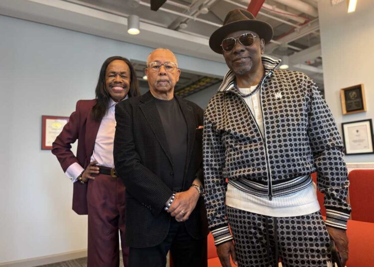 Earth, Wind & Fire members Verdine White, left, Ralph Johnson, center, and Philip Bailey pose for a portrait at NPR's New York bureau on June 2. The band members spoke with Morning Edition about the new HBO documentary Earth, Wind & Fire (To Be Celestial vs That's the Weight of the World)