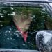 Andrew Mountbatten-Windsor driving a Land Rover, with a prominent red mark on his cheek.