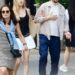 Jason Biggs holding his chest as Jenny Mollen guides him by his arm.