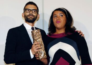French directors Marjane Satrapi (R) and Vincent Paronnaud pose with their award for best debut film for
