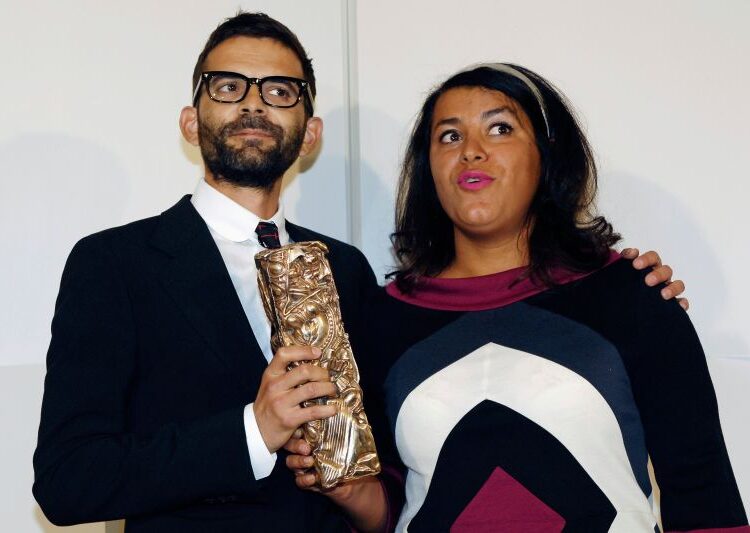 French directors Marjane Satrapi (R) and Vincent Paronnaud pose with their award for best debut film for