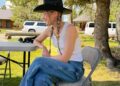 Gigi Hadid wore jeans, cowboy boots, a tank top, and Western hat inspired by her sister, Bella Hadid.