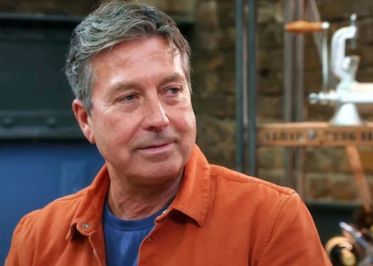 John Torode pictured on series 19 of Masterchef, wearing an orange shirt
