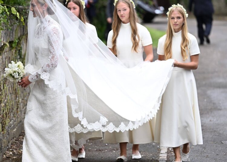 Harriet Sperling arrives for her wedding to Peter Phillips followed by her bridesmaids Georgina Sperling, Savannah Phillips and Isla Phillips at All Saints Church