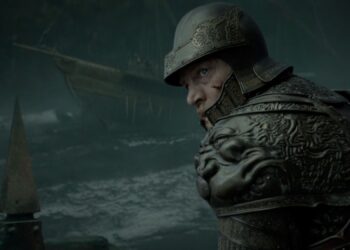 A man in armour heads in to battle on a ship.