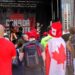 People wearing red or Canadian flags watch a band performing on a stage
