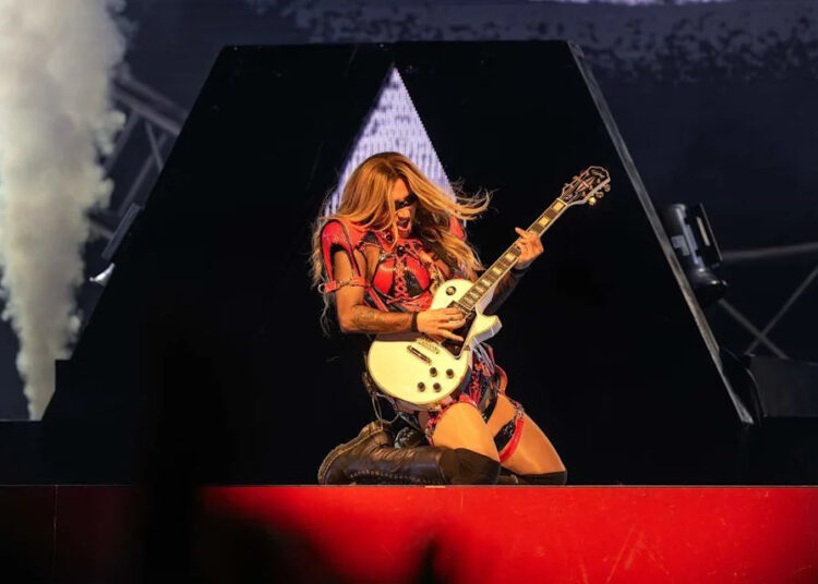 Singer Kesha plays the guitar while preforming the song “Thinking of You” during her Freedom Tour at the Morton Amphitheater on Wednesday, June 3, 2026, in Riverside.