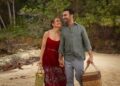 Jennifer Lopez and Brett Goldstein smiling together on a beach in