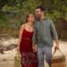 Jennifer Lopez and Brett Goldstein smiling together on a beach in
