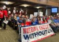 Members of Stand Up KC and the Missouri Workers Center pack Kansas City Council chambers on Thursday to oppose the passage of a financing deal for a new Royals stadium. Sitting behind and around them are members of the building trades unions, who support the deal.