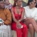 People seated in a fashion show front row, dressed stylishly.