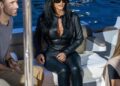 Kim Kardashian wears a two-piece leather Gucci racing suit and carries a matching Gucci bag to support boyfriend Lewis Hamilton at the Monaco Grand Prix