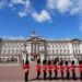 Soldiers march near the entrance to a palace.