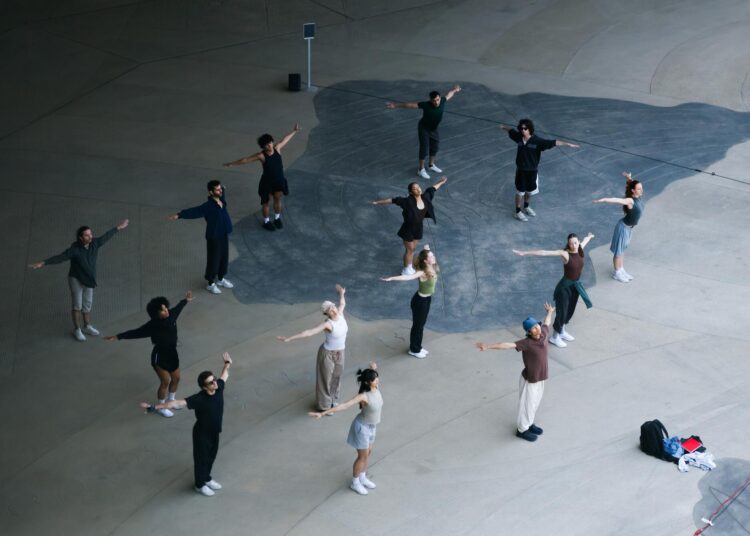 Dancers from above on a concrete floor.