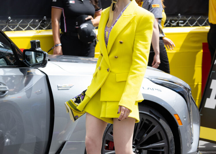Lily Collins pulled off a neon green and purple color combination at the Formula 1 Monaco Grand Prix