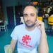 Caleb Willdee, an executive producer for Love Island USA, wearing a white t-shirt with a red "Pretty Swede Records" logo.