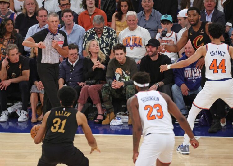Actors Ben Stiller, Christine Taylor, Michael J. Fox, and Timothée Chalamet sit courtside at an NBA Eastern Conference Finals game.