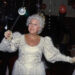 Jean Stapleton in a white dress with a wand on break during the filming of tv special 'Cinderella'.
