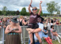 Chris Kelly, 40, of Atlanta holds his stepdaughter, Hannah Boyd, 8, during The Country Fest on June 18 at Clay's Resort Jellystone Park in Stark County. At left is Hannah's mother, Tasha Thatcher, 34, also of Atlanta.