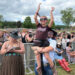 Chris Kelly, 40, of Atlanta holds his stepdaughter, Hannah Boyd, 8, during The Country Fest on June 18 at Clay's Resort Jellystone Park in Stark County. At left is Hannah's mother, Tasha Thatcher, 34, also of Atlanta.