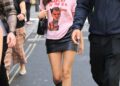 Olivia Rodrigo wore a graphic tee and leather mini skirt with an on-sale Coach bag