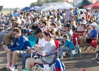 A large crowd of spectators keep their eyes to the sky for the aerobatics entertainment at the Texarkana Airshow on Saturday, June 27, 2026, at Texarkana Regional Airport. Besides the aerial displays, the show featured a musical concert, an exotic car exhibition, several vendors and tours of vintage military aircraft. (Staff photo by Stevon Gamble)