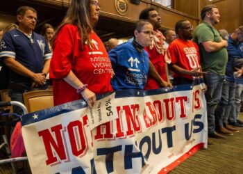 Members of Stand Up KC attend a City Council meeting ahead of a vote on the potential relocation of the Kansas City Royals baseball stadium to the downtown area, on Thursday, April 16, 2026.