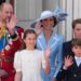 Prince William and Princess Kate and their three children, smile and wave on a balcony.