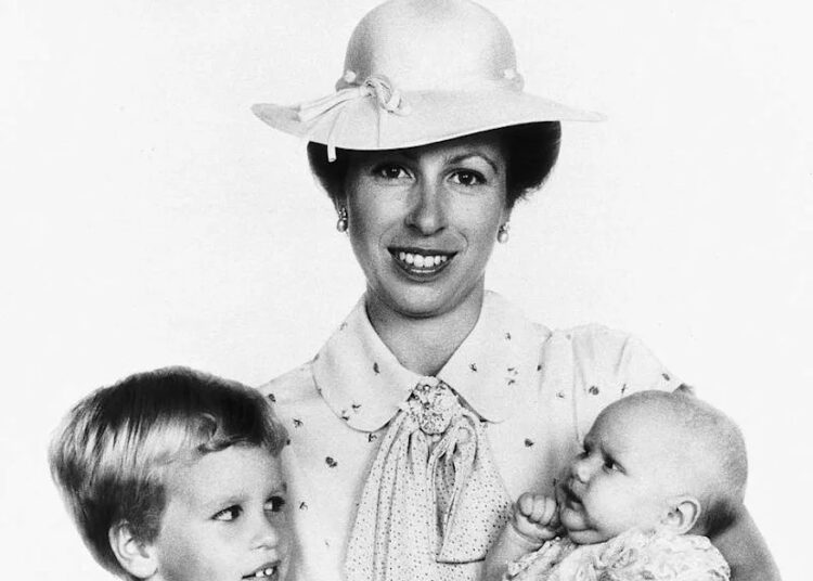 Peter Phillips, Princess Anne and Zara Tindall pose during Zara's christening in 1981. By: MEGA