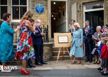Queen Camilla leaves the Brontë house to a round of applause.