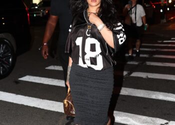 Rihanna styled the sports jersey trend with Nike sneakers and a Louis Vuitton Speedy Bag in NYC