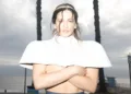 Photo of a woman wearing a white top .
