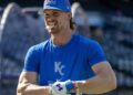 Kansas City Royals shortstop Bobby Witt Jr. (7) holds a batting accessory in his mouth during batting practice before a baseball game against the Houston Astros on Friday, June 12, 2026, at Kauffman Stadium in Kansas City.