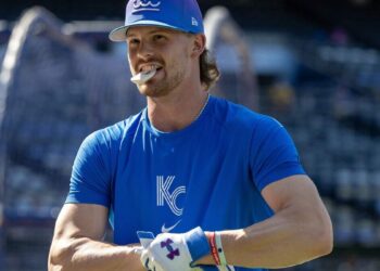 Kansas City Royals shortstop Bobby Witt Jr. (7) holds a batting accessory in his mouth during batting practice before a baseball game against the Houston Astros on Friday, June 12, 2026, at Kauffman Stadium in Kansas City.