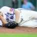 Kansas City Royals pitcher Seth Lugo dropping to the mound after being hit by a line drive.