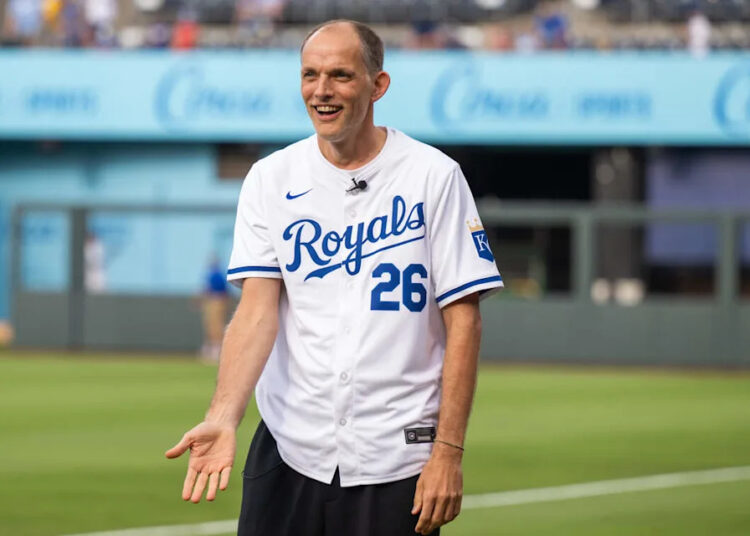 England national soccer team manager Thomas Tuchel wears a Royals jersey while visiting the team ahead of KC’s game against the St. Louis Cardinals at Kauffman Stadium in Kansas City on Thursday, June 18, 2026.